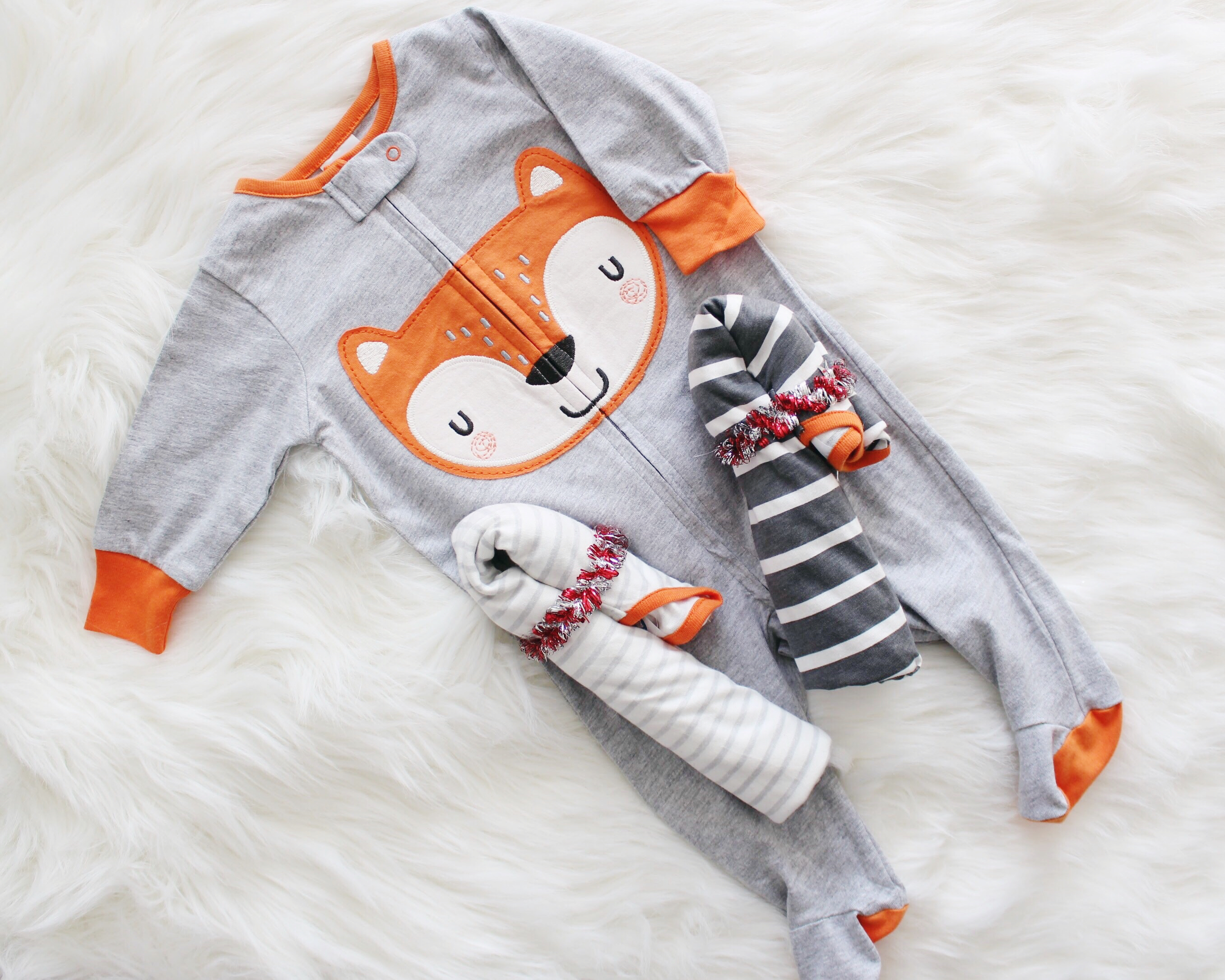 The perfect essentials you need for your Baby's First Christmas! Plus see how to fold onesies like a candy cane! Check it out!