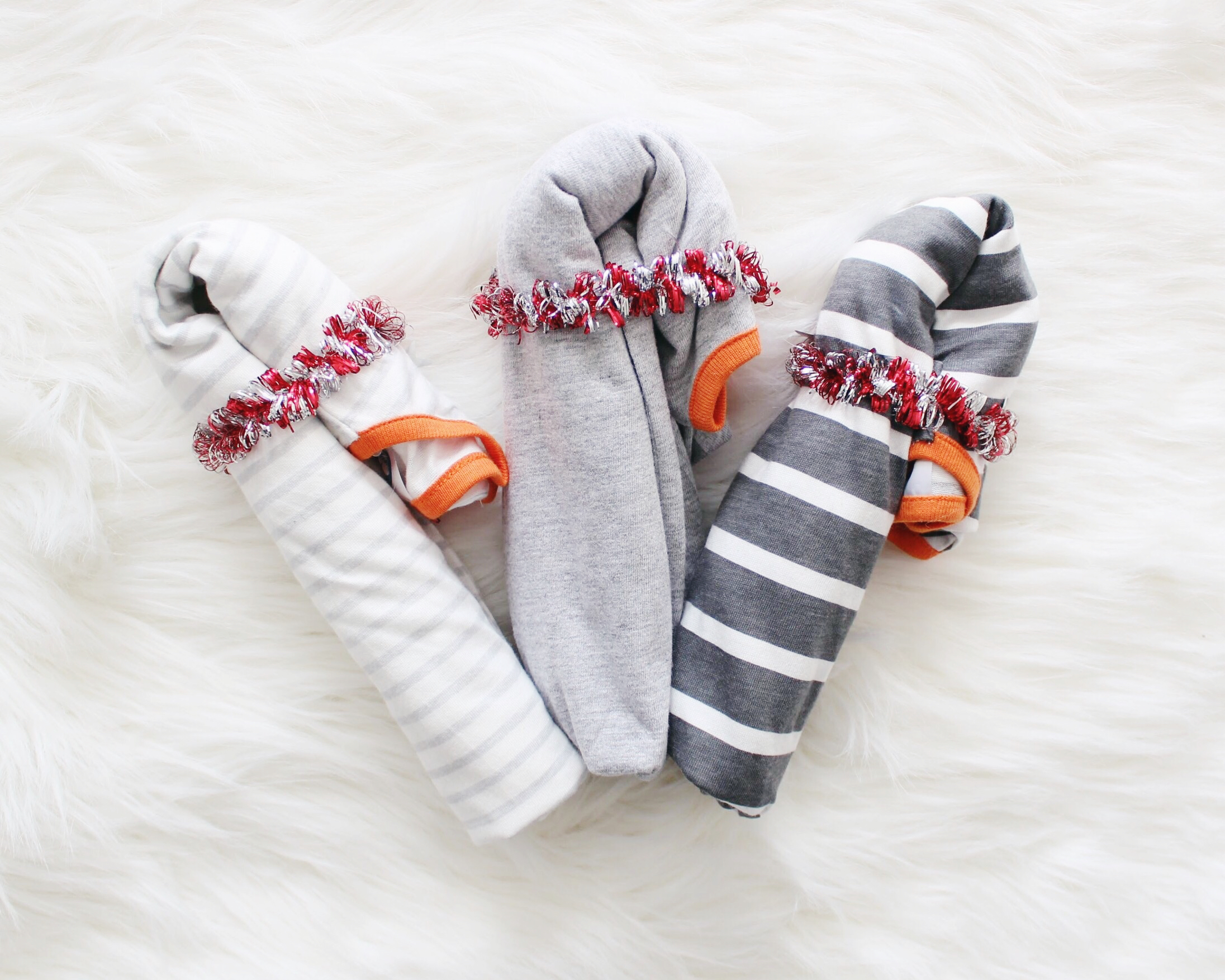 The perfect essentials you need for your Baby's First Christmas! Plus see how to fold onesies like a candy cane! Check it out!