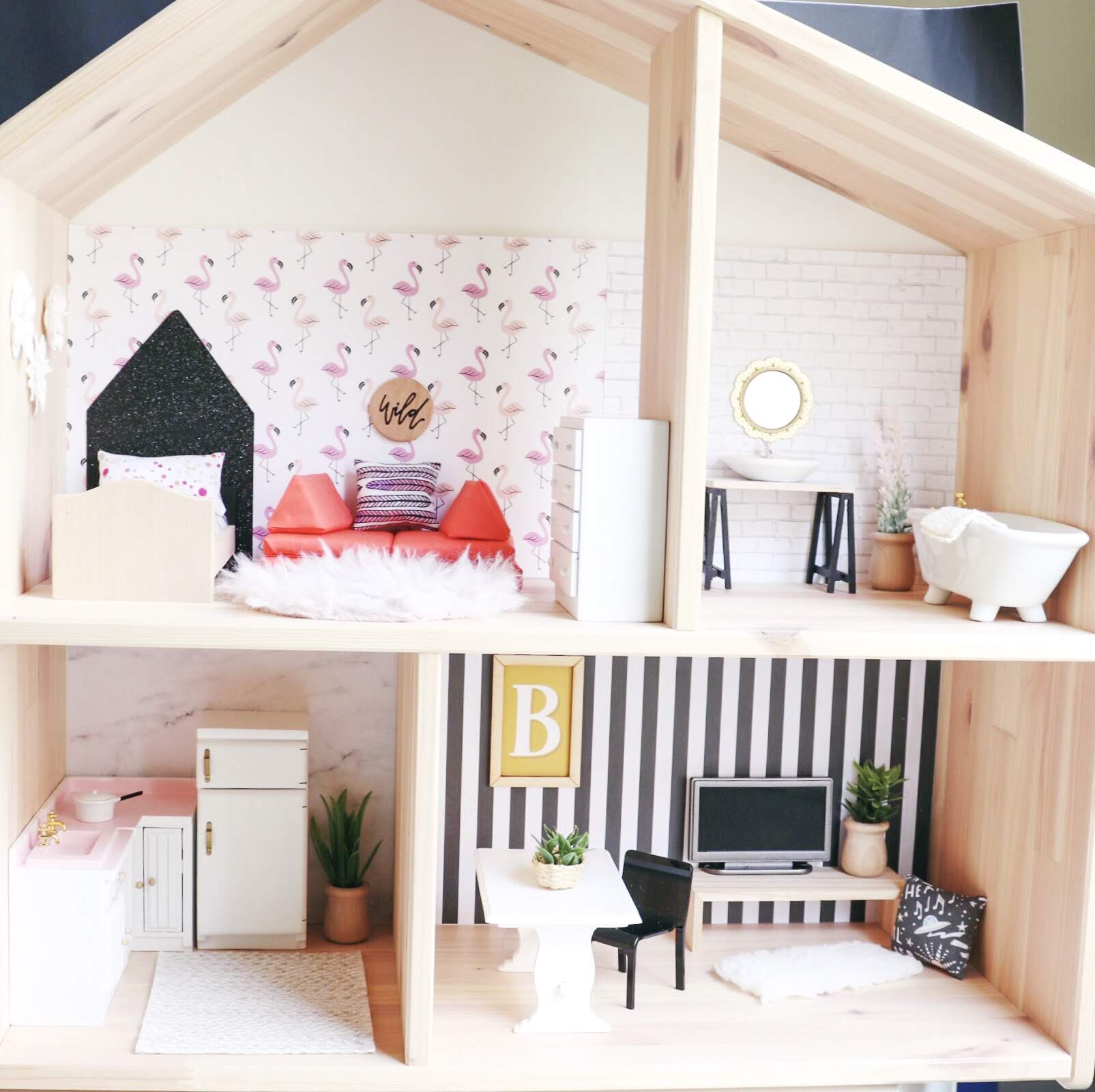 Oh Happy Play, Florida Motherhood blogger shares an easy tutorial for creating a custom dollhouse. Check it out now to find out how to build one yourself!