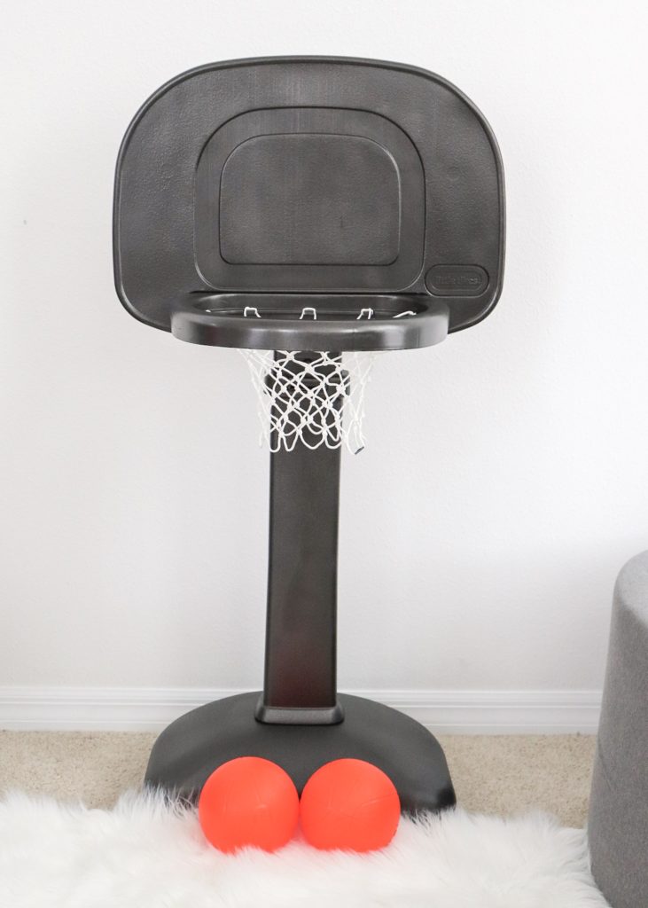 Want to create a monochrome nursery? A big bright basketball hoop may not be the right aesthetic. Check out this DIY Painted Plastic Basketball Hoop for Toddlers!