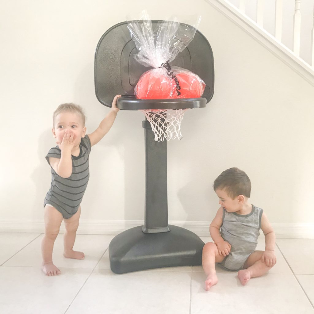 Want to create a monochrome nursery? A big bright basketball hoop may not be the right aesthetic. Check out this DIY Painted Plastic Basketball Hoop for Toddlers!